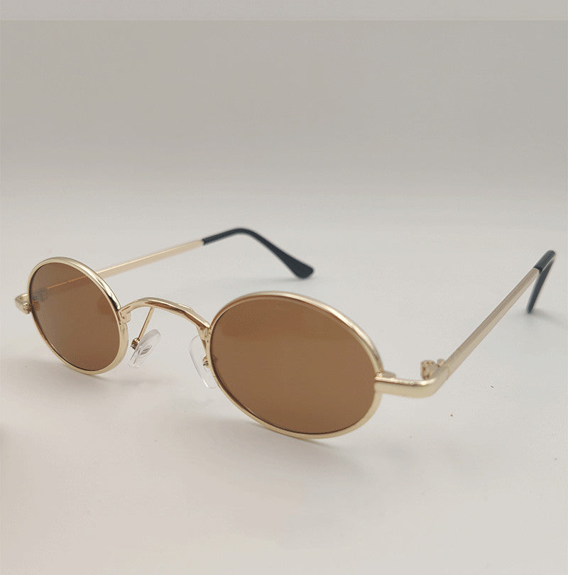 Brown oval dog sunglasses toy on white background with black ear tips