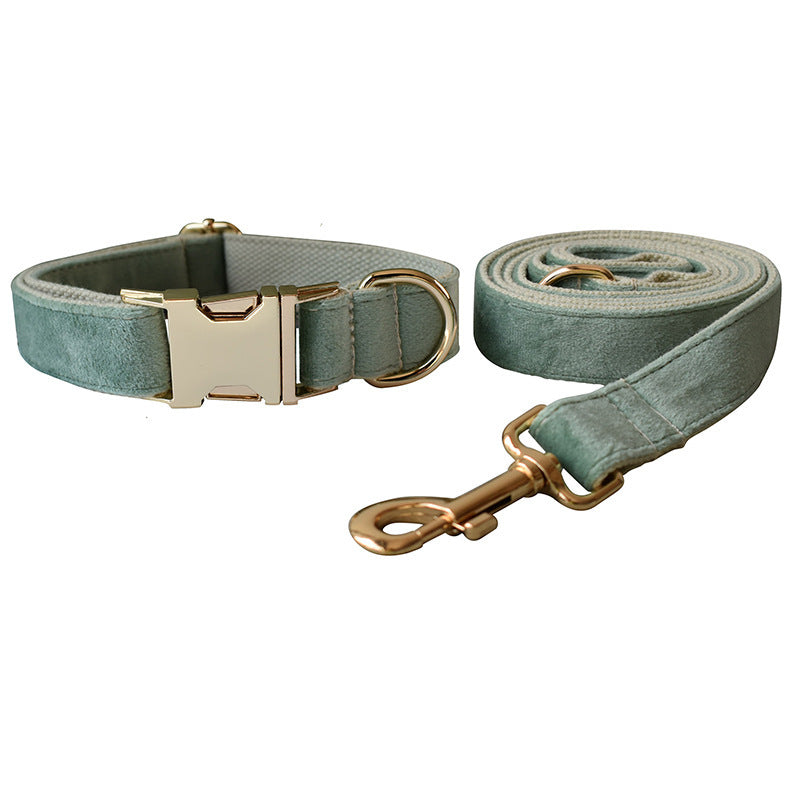 Detailed view of adjustable mint green velvet dog collar with gold buckle and leash hardware