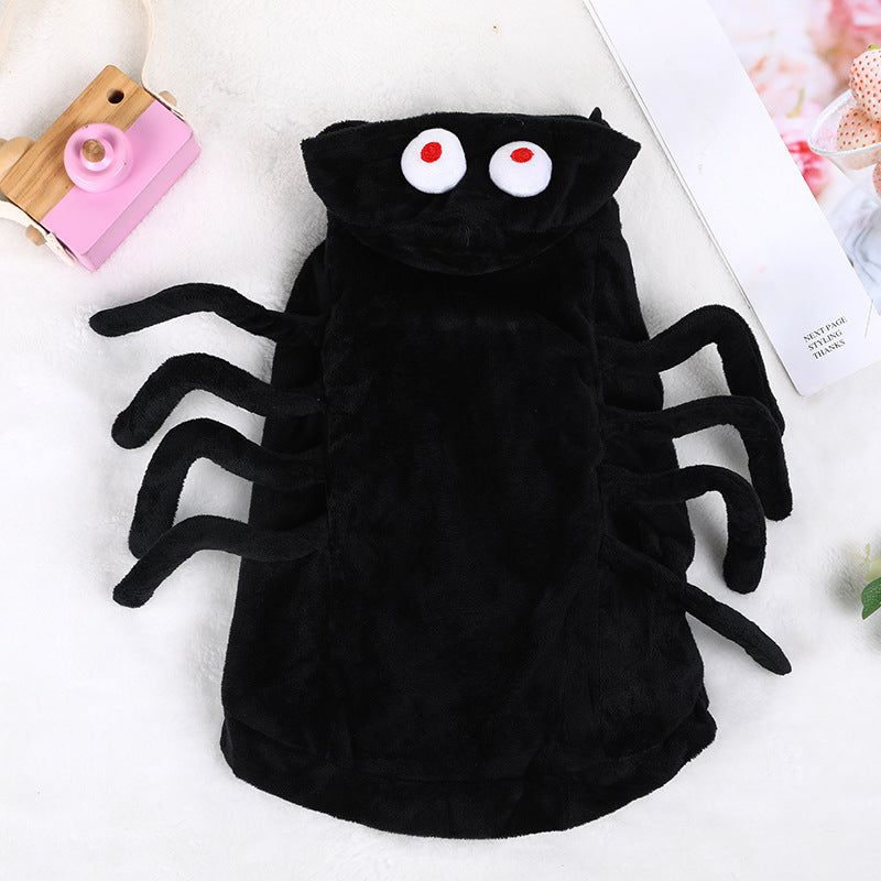 Close-up of black plush spider pet hoodie showing the hood with two large white eyes and the eight spider legs