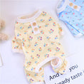 Load image into Gallery viewer, Blue floral dog pajamas displayed with white ribbed trims on cuffs and collar
