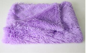 Purple plush pet blanket folded, highlighting soft material