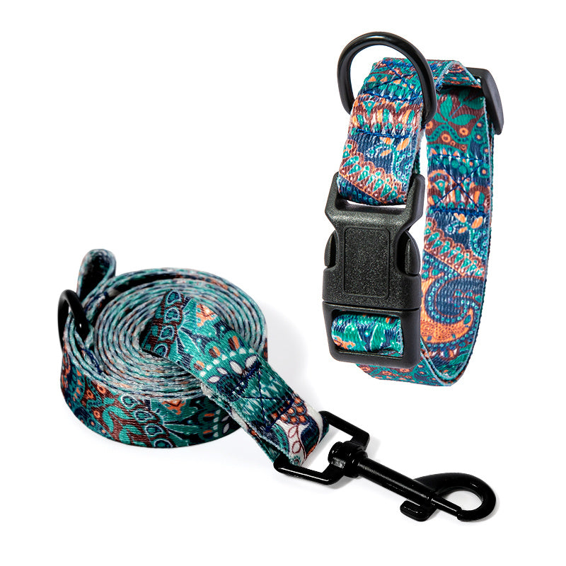 Set of dog collar and matching leash in green, orange, and blue paisley pattern displayed on white background