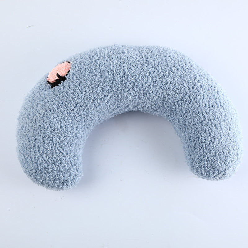 Light blue U-shaped plush pet pillow with pink flower embroidery on white background