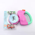 Load image into Gallery viewer, Packaged pink and green dual retractable dog leash featuring blue graphic of dog on spool, with leash clips visible
