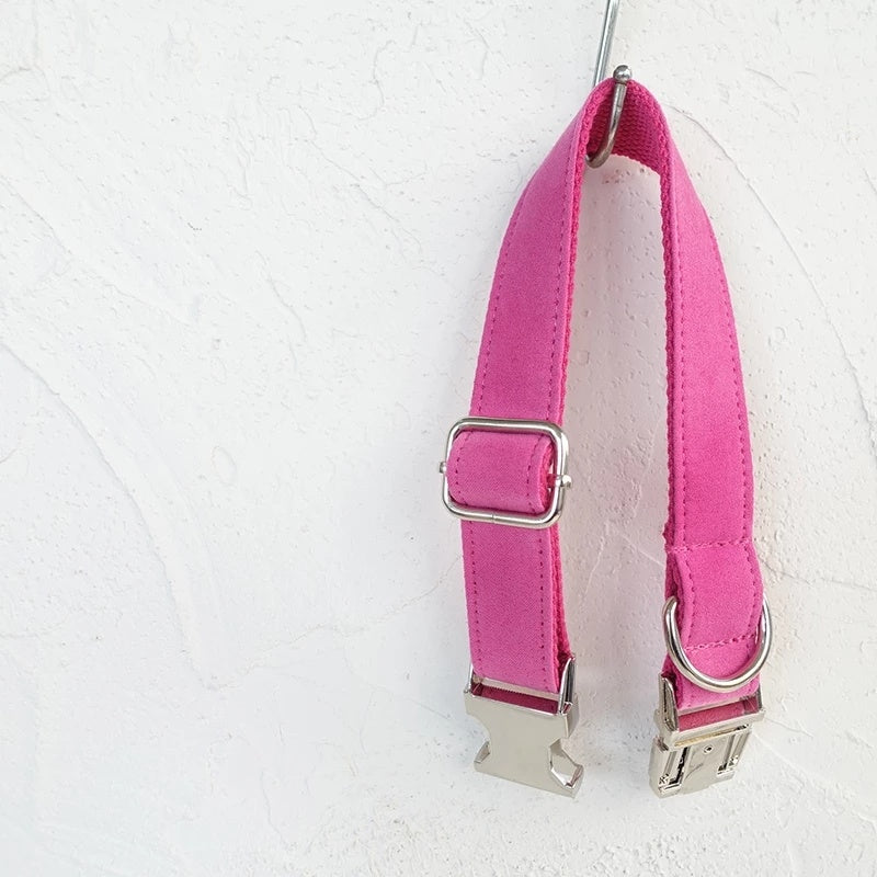 Pink velvet adjustable collar hanging on white wall