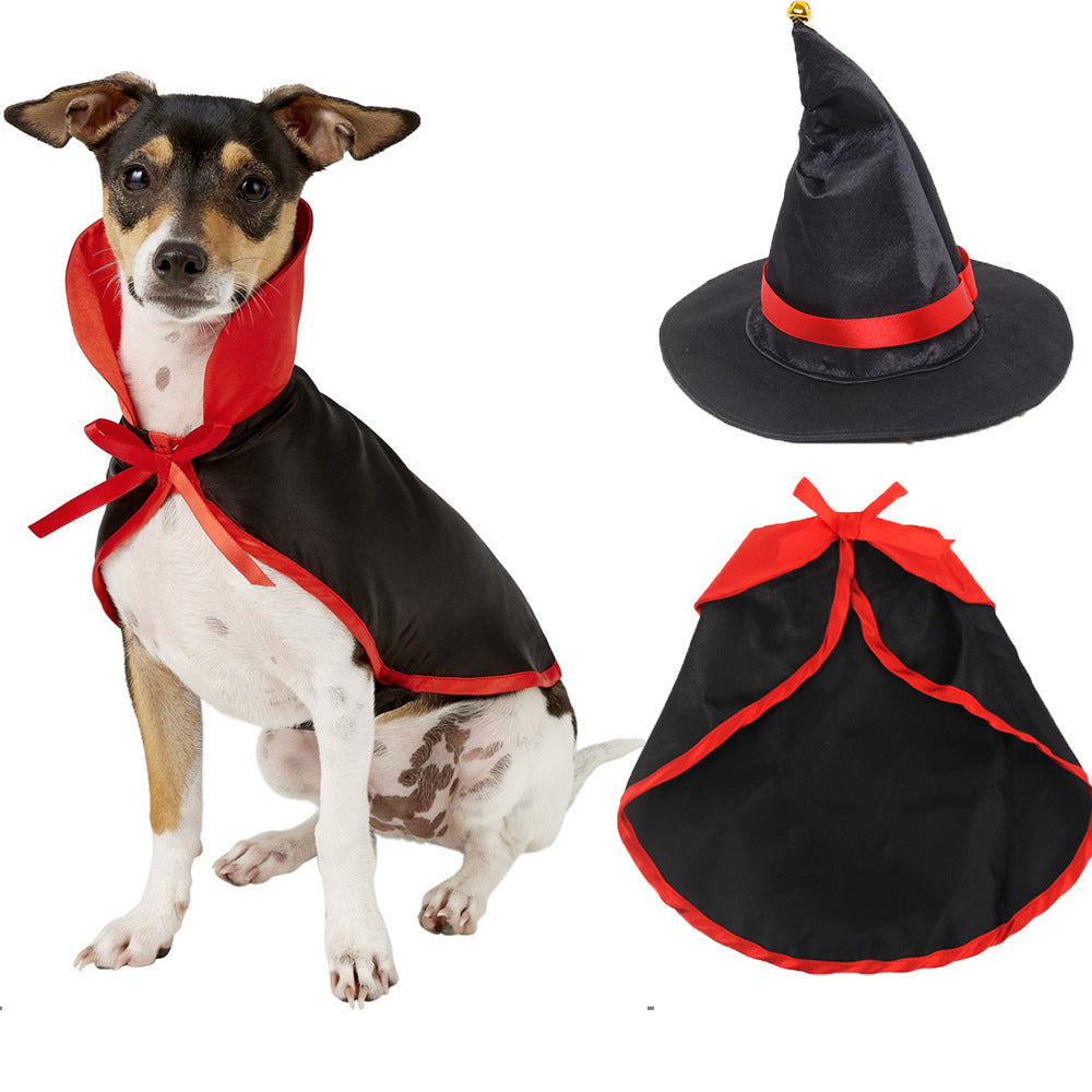 Small dog wearing black and red witch costume cape with red bow
