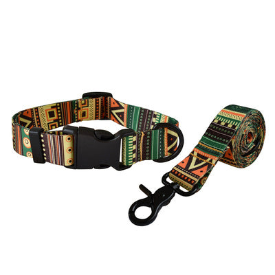 Green, orange, and black geometric patterned dog collar and leash set isolated on white background