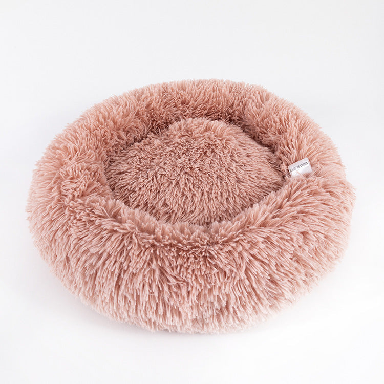 Dusty pink plush round pet bed with raised rim in soft faux fur fabric