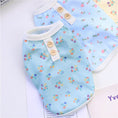 Load image into Gallery viewer, Two floral dog pajamas in blue and yellow colors laid next to each other
