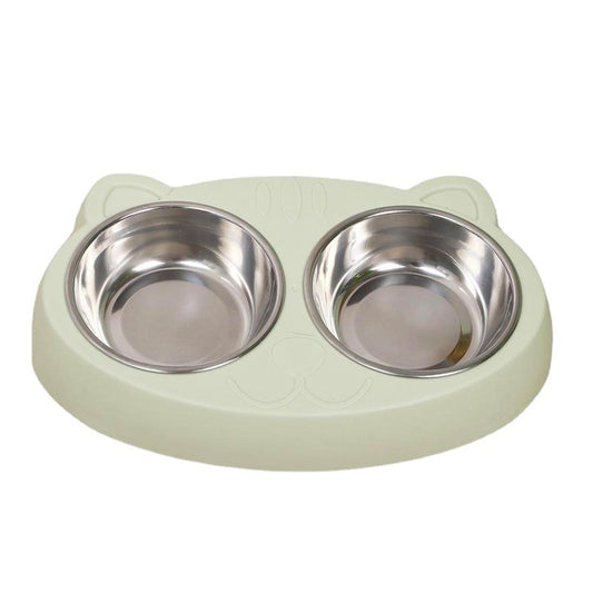 Top view of empty stainless steel double bowls placed in pale green cat-shaped plastic base