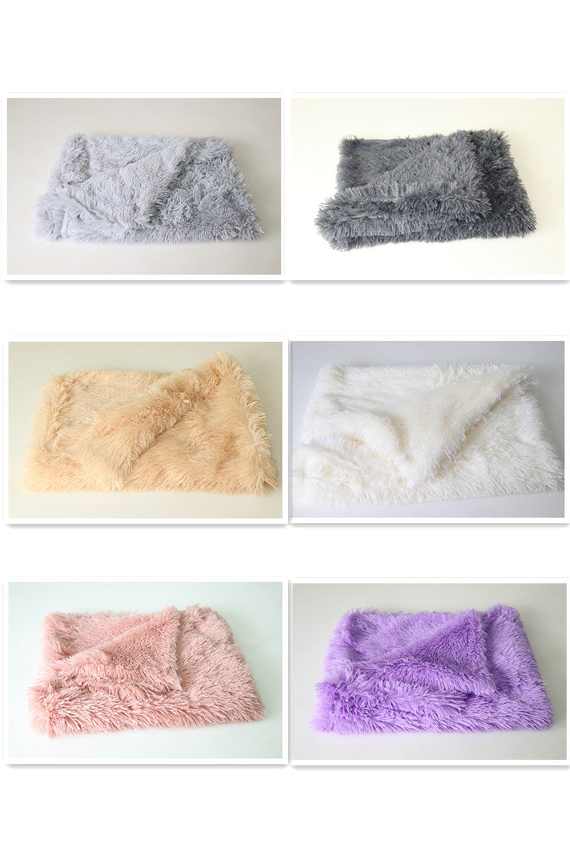 Variety of plush pet blankets folded, showing light gray and dark gray colors