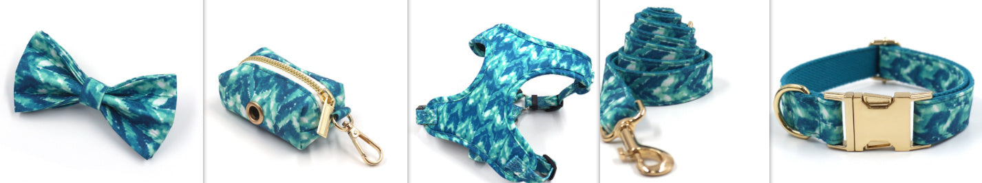 Set of dog accessories featuring blue tie-dye bow tie, waste bag holder, harness, leash, and collar
