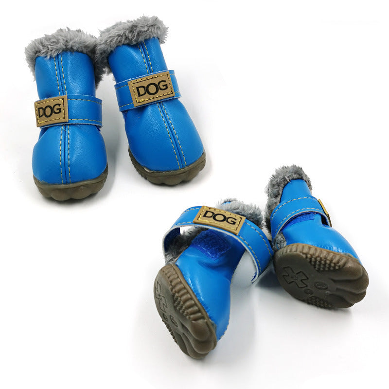 Bright blue dog boots with gray fur lining and rubber sole showing tread pattern
