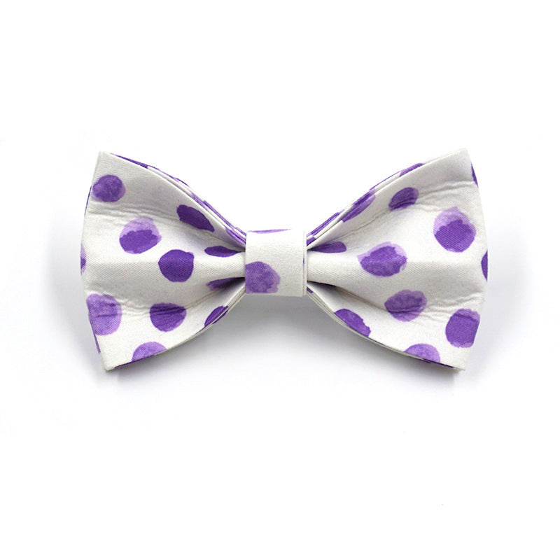 Close-up of purple polka dot bow tie accessory for dog collar