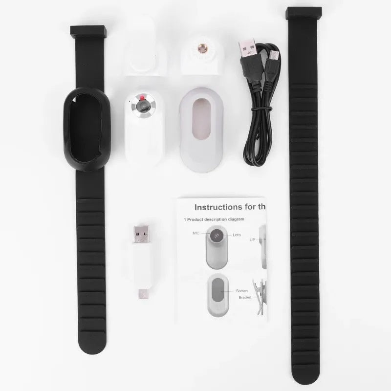 Unassembled white camera components laid out with collar, cables, and instructions