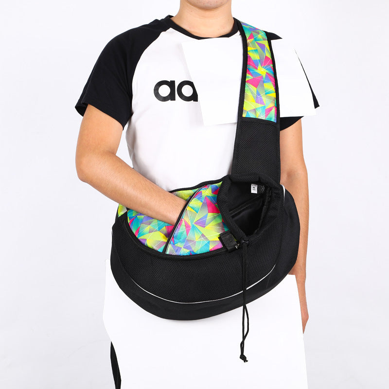 Man wearing colorfully patterned breathable pet sling carrier without pet inside