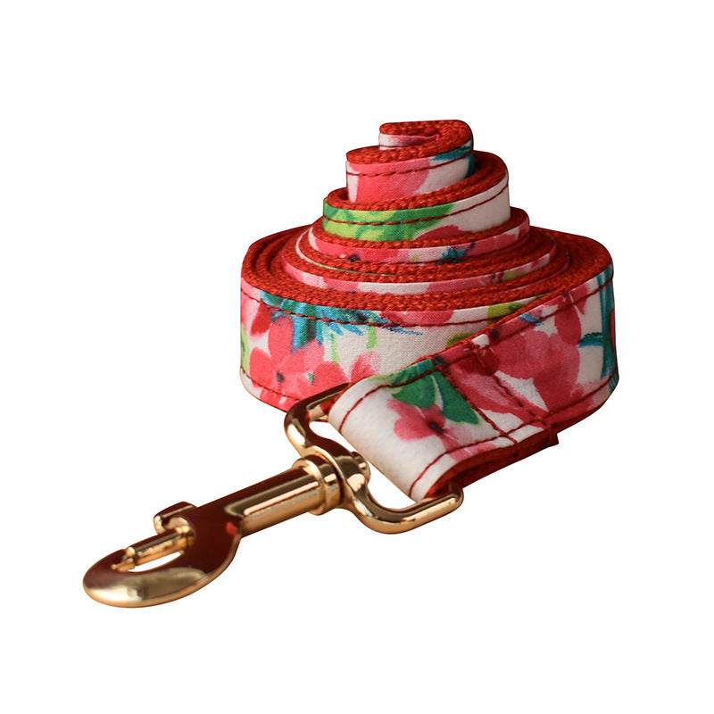 Rolled red floral dog leash showing fabric pattern