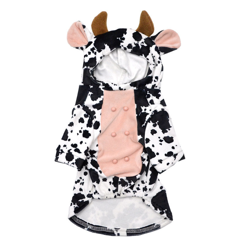 Flat lay of the black and white spotted velvet cow costume for dogs with hood, ears, horns, and pink textured belly