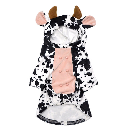 Flat lay of the black and white spotted velvet cow costume for dogs with hood, ears, horns, and pink textured belly