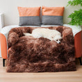 Cargar la imagen en la vista de la galería, White dog comfortably resting on brown plush pet mat nest placed on living room floor near orange couch

