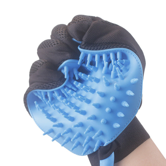 Close-up of flexible blue silicone brush on black pet bathing glove showing soft massage nubs