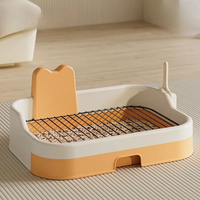 Beige and peach portable dog potty tray with metal grate and splash guard angled on light background
