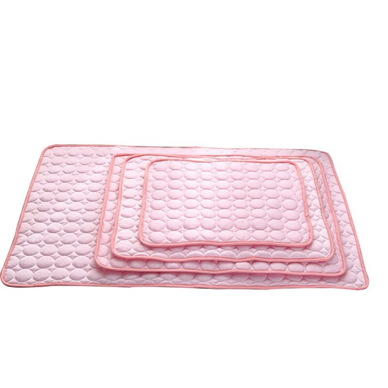Same set of pink pet cooling mats stacked, showing quilted bubble texture and pink binding