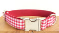 Load image into Gallery viewer, Close-up of red and white checkered dog collar with metal buckle on wooden surface
