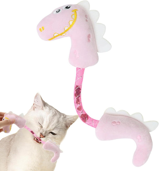 White cat chewing on a pink plush dinosaur-shaped cat toy with flexible body