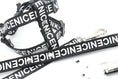Cargar la imagen en la vista de la galería, Black nylon dog harness and leash featuring NICENICENICE print and metal clasp
