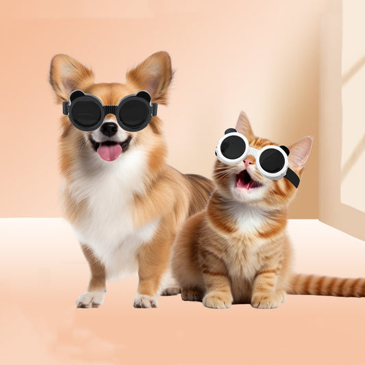 Dog and cat wearing black and white UV protective goggles with bear-ear design