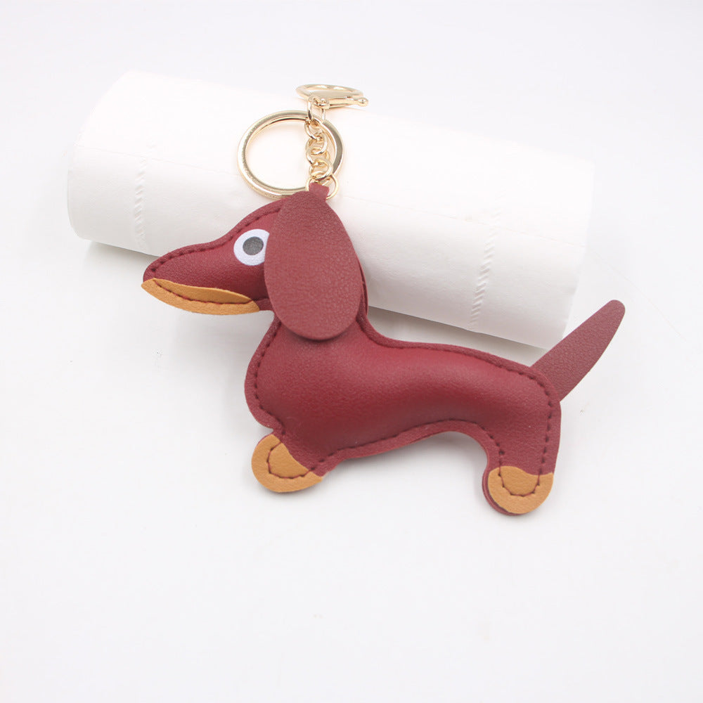 Red faux leather sausage dog keychain displayed on white background