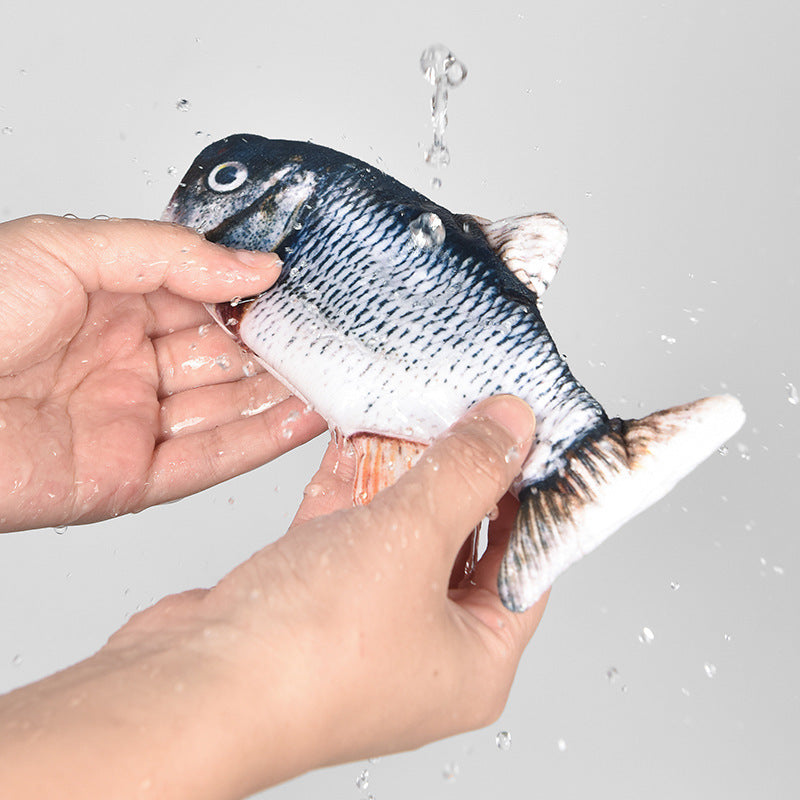 Hands washing soft fabric fish cat toy under running water