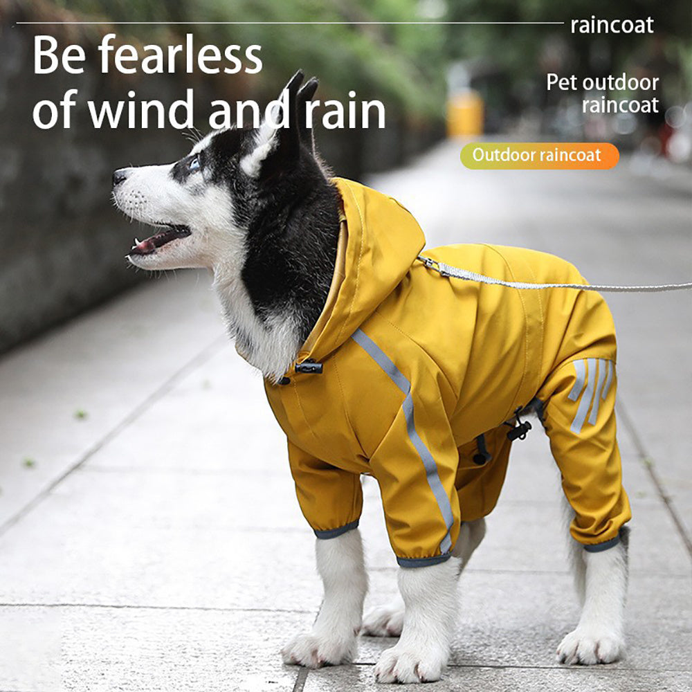 Husky puppy standing on sidewalk wearing yellow waterproof raincoat with reflective stripes on legs and sleeves