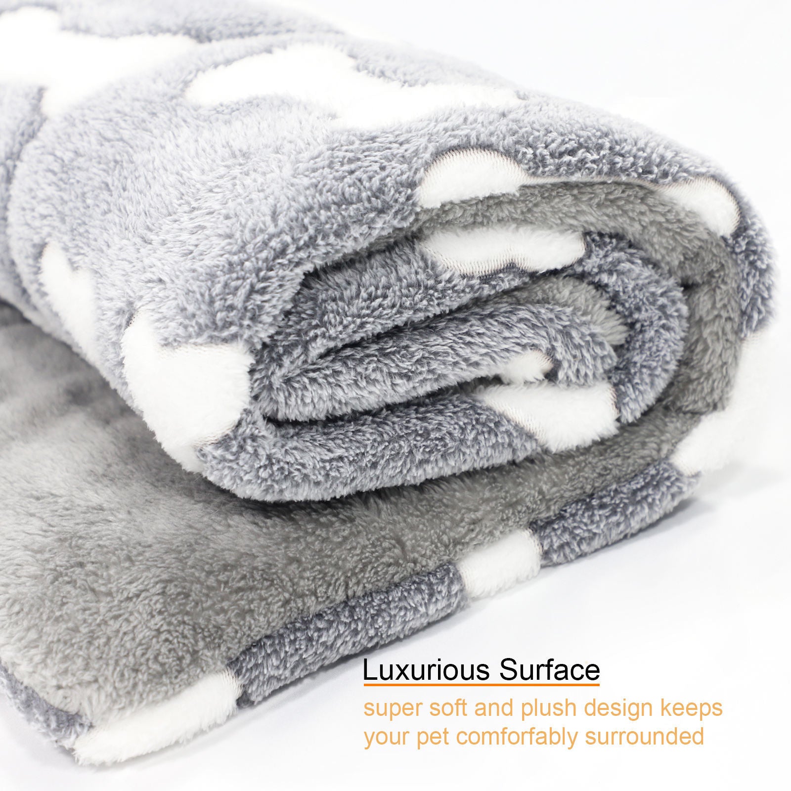 Rolled plush gray pet bed mat with white bone pattern showing thick soft material