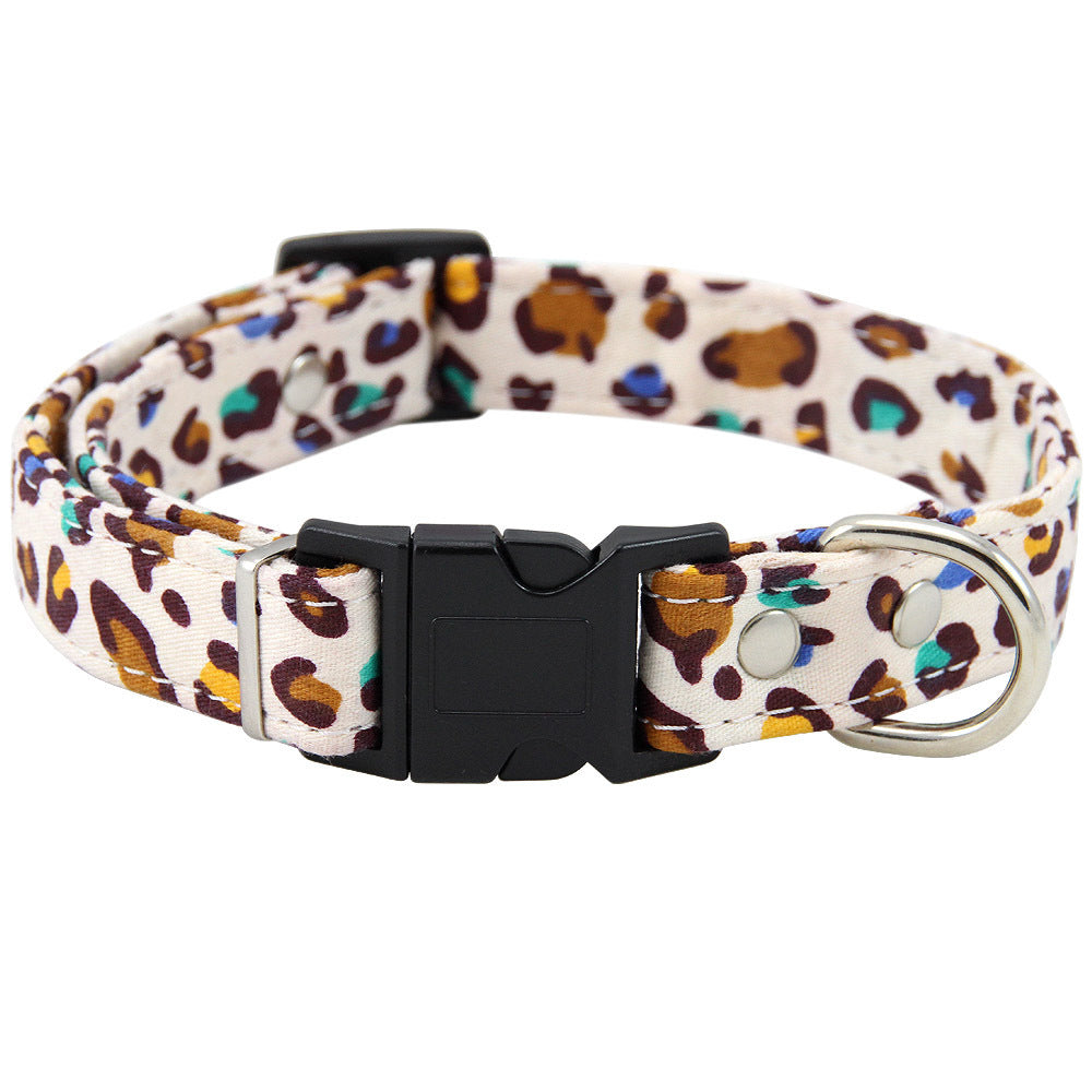 Close-up of adjustable leopard print dog collar with metal D-ring and black buckle