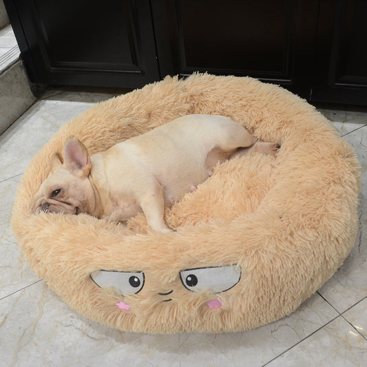 Beige plush round pet bed with an embroidered face and small dog resting inside