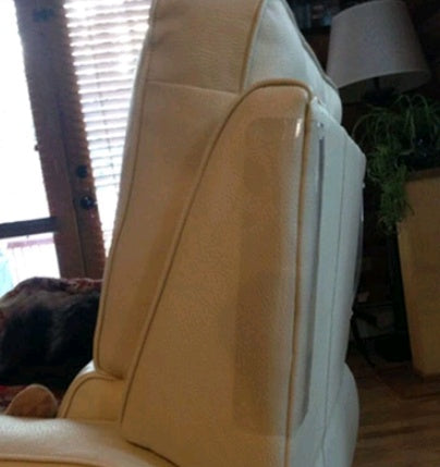 Clear claw protector pad attached to the side of a beige leather chair