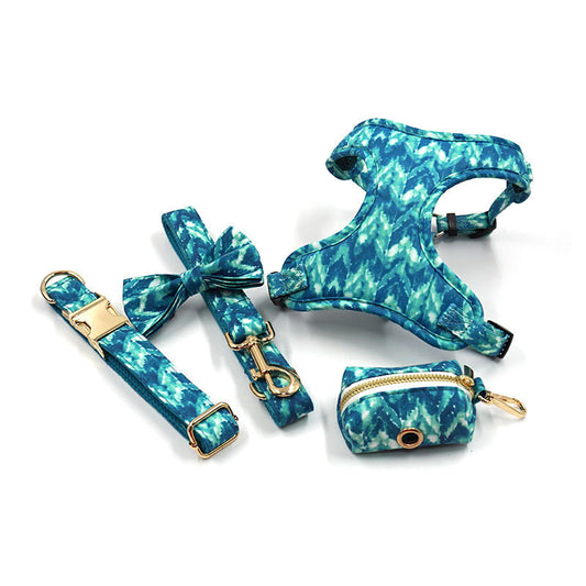 Blue tie-dye dog collar leash bow knot harness and waste bag holder set laid out