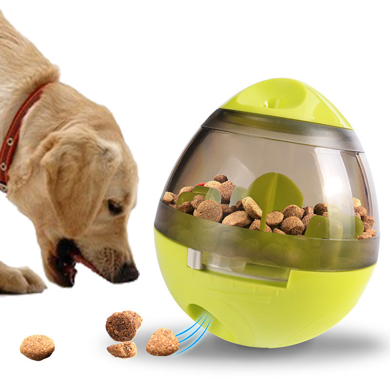 Dog eating kibble from lime green interactive pet food dispenser releasing food pellets