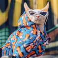 Load image into Gallery viewer, Hairless cat wearing sunglasses and colorful graphic hoodie outdoors
