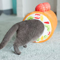 Load image into Gallery viewer, Gray cat entering the cake roll cat tunnel through a round fruit-patterned entrance
