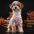 Charger l'image dans la visionneuse de la galerie, Front view of fluffy dog wearing white blood splatter costume with yellow Do Not Enter sash and Halloween decorations in background
