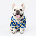Load image into Gallery viewer, Front view of a white dog wearing the blue duck print shirt with tongue out
