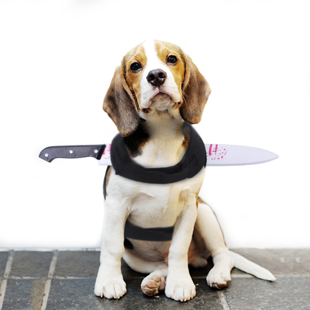 Beagle dog sitting wearing black harness with fake bloody knife prop attached behind neck