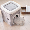 Load image into Gallery viewer, Cat entering the gray plush cat cave with white trim with a mouse toy hanging inside and a wooden tray nearby
