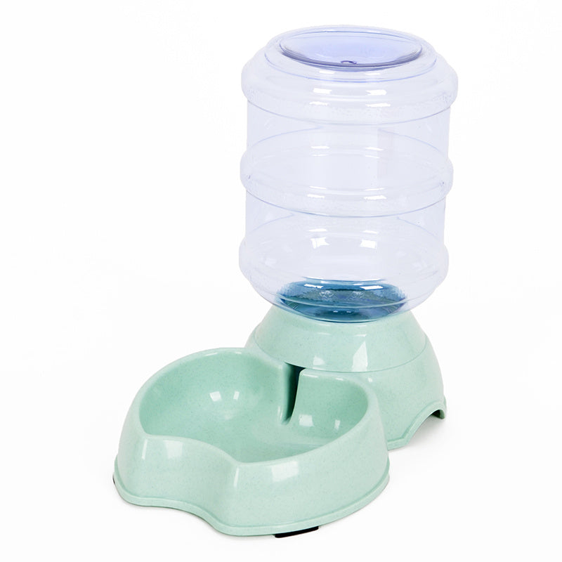 Light green pet feeding station with transparent large water container and curved food bowl base on white background