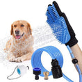 Load image into Gallery viewer, Black pet bathing glove with blue silicone brush, attached to blue hose and faucet adapters, spraying water on a golden retriever dog
