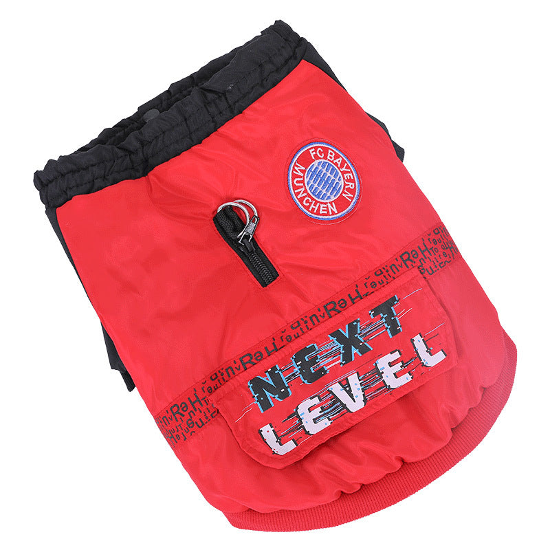 Flat lay detail of red and black dog jacket showing embroidered FC Bayern Munich patch and zipper with loop