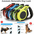 Cargar la imagen en la vista de la galería, Four automatic retractable dog leashes in red, blue, green, and yellow colors displayed side by side
